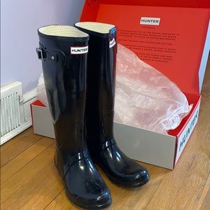 Tall glossy black hunter boots